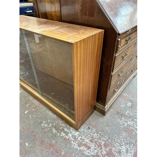 160 - A mid 20th century teak bookcase with two glass sliding doors