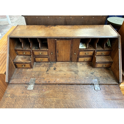 161 - A George III oak and mahogany crossbanded bureau with four drawers, fall front, fitted interior and ... 