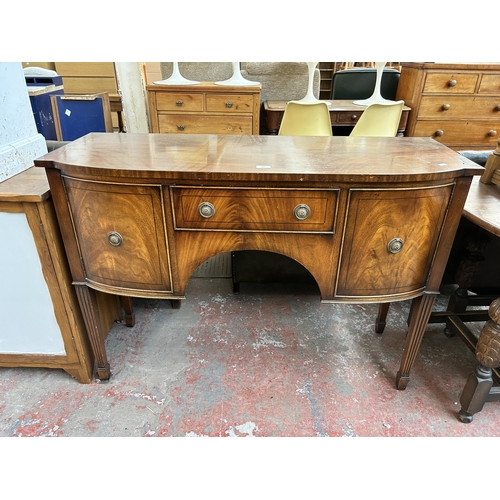 165 - A Jaycee Regency style mahogany sideboard with two cupboard doors, single drawer and tapered support... 