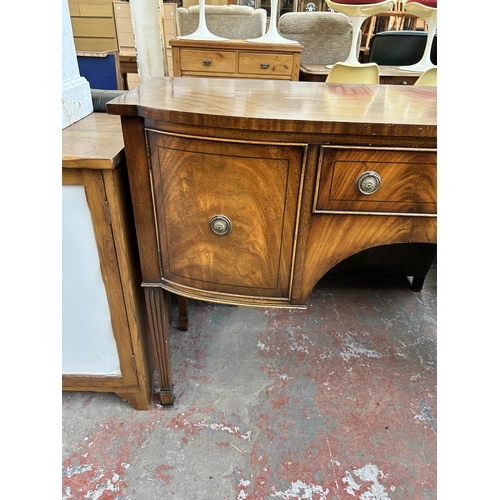 165 - A Jaycee Regency style mahogany sideboard with two cupboard doors, single drawer and tapered support... 