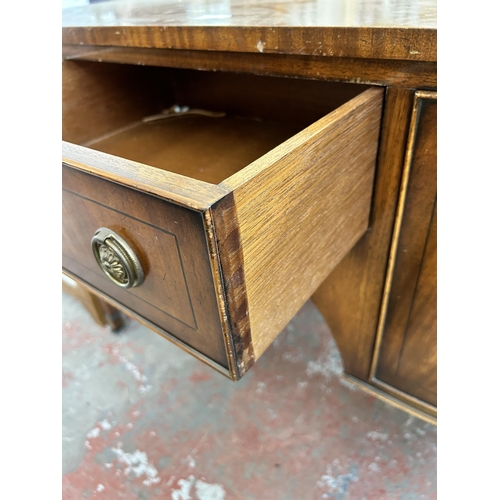 165 - A Jaycee Regency style mahogany sideboard with two cupboard doors, single drawer and tapered support... 