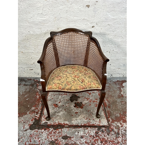 168 - An early 20th century beech, cane and tapestry upholstered bergere armchair