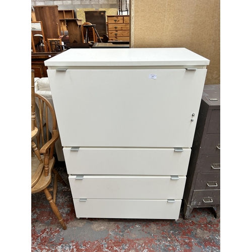 179 - A modern white laminate cabinet with fall front and three lower drawers