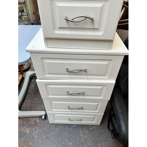 183 - A modern white laminate two piece bedroom suite comprising bedside chest of two drawers and chest of... 
