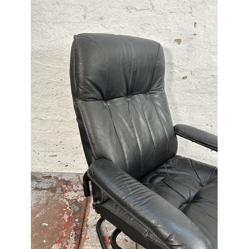 184 - A Danish Unico black leather swivel armchair and footstool