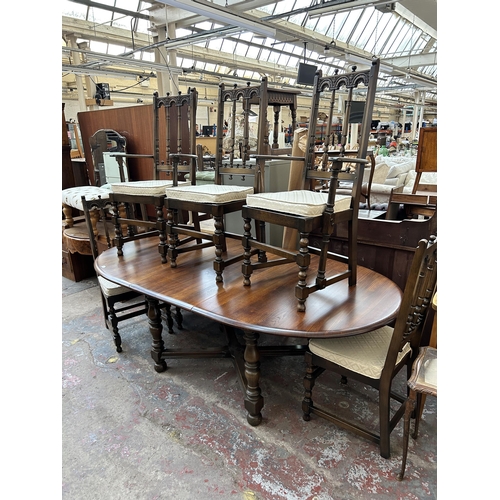 190 - An Ercol Old Colonial elm extending dining table and six Ercol Old Colonial Yorkshire dining chairs