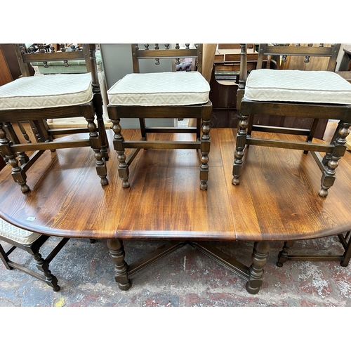 190 - An Ercol Old Colonial elm extending dining table and six Ercol Old Colonial Yorkshire dining chairs