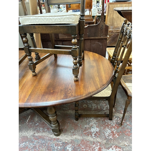 190 - An Ercol Old Colonial elm extending dining table and six Ercol Old Colonial Yorkshire dining chairs