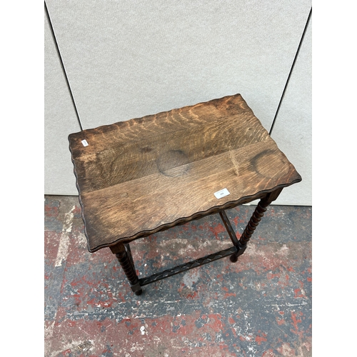 193 - An early 20th century oak pie crust edge side table on barley twist supports