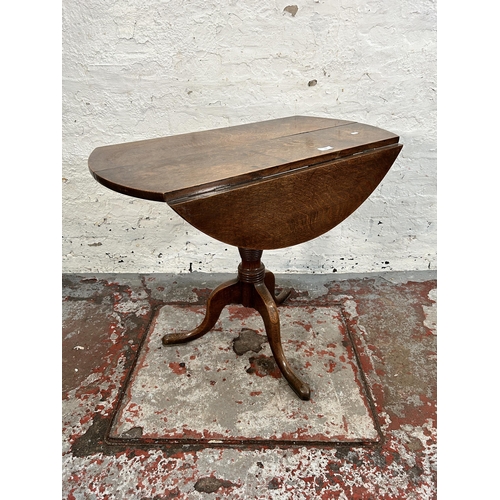 200 - A Georgian oak drop leaf circular tilt top occasional table on tripod pedestal support