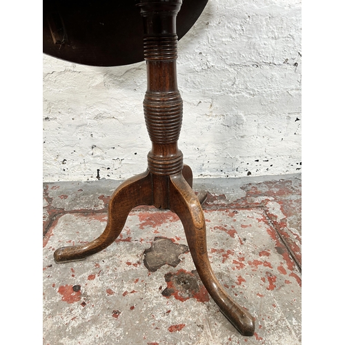 200 - A Georgian oak drop leaf circular tilt top occasional table on tripod pedestal support