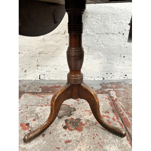 200 - A Georgian oak drop leaf circular tilt top occasional table on tripod pedestal support