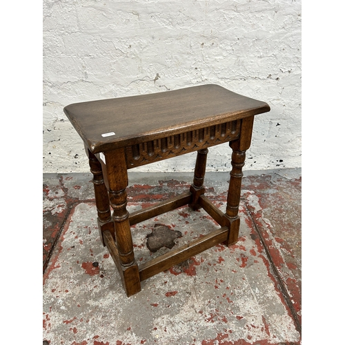 203 - A 17th century style carved oak joint side table