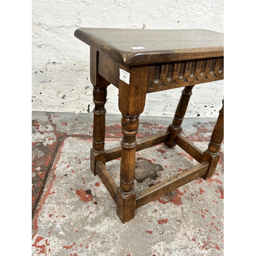 203 - A 17th century style carved oak joint side table