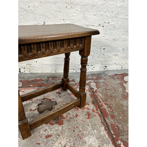 203 - A 17th century style carved oak joint side table