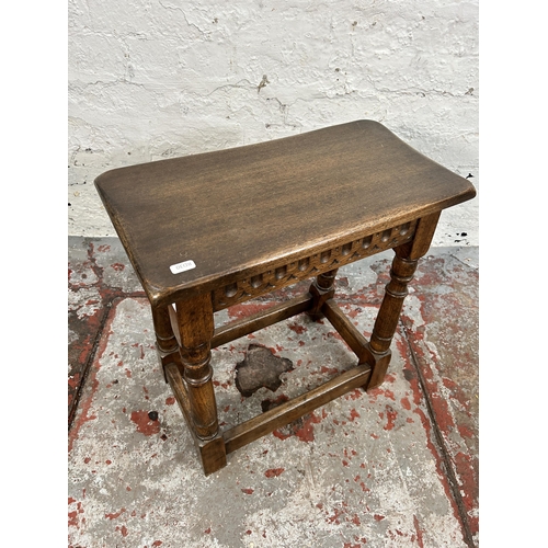 203 - A 17th century style carved oak joint side table