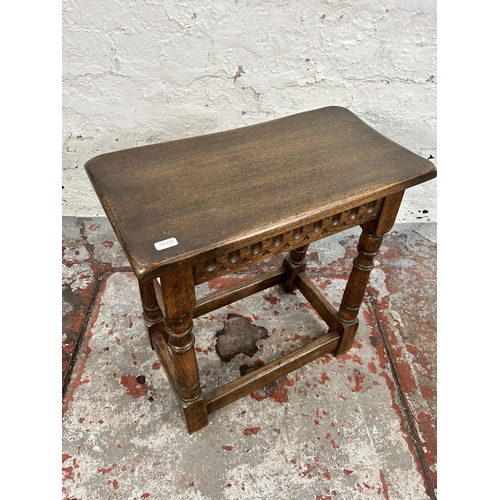 203 - A 17th century style carved oak joint side table