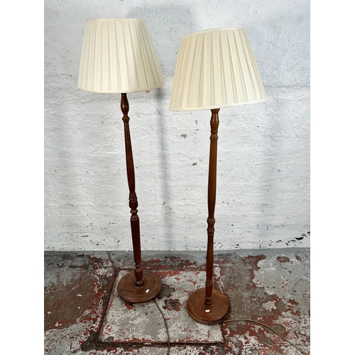 210 - Two beech standard lamps