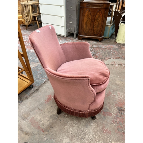 213 - A mid 20th century pink fabric upholstered wingback bedroom chair with mahogany cabriole supports