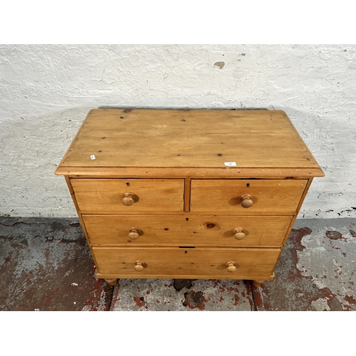 214 - A Victorian pine chest of two short over two long drawers with turned supports