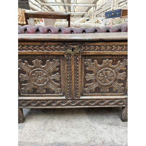 224 - A Charles II carved oak two panel coffer - approx. 59cm high x 95cm long x 48cm deep