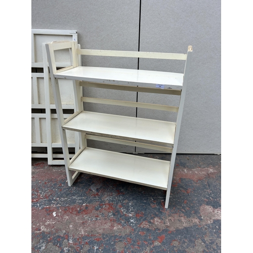 233 - Two mid 20th century collapsible three tier bookshelves