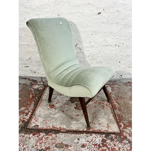 242 - A mid 20th century green fabric upholstered lounge chair with splayed supports