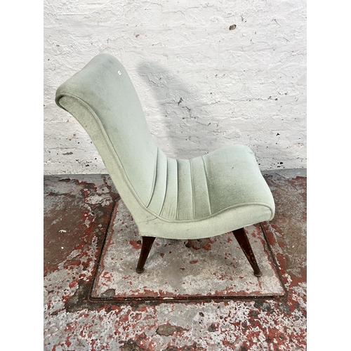 242 - A mid 20th century green fabric upholstered lounge chair with splayed supports