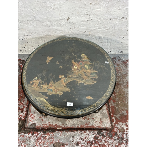 243 - An Oriental hand painted and ebonized circular occasional table with glass top