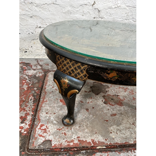 243 - An Oriental hand painted and ebonized circular occasional table with glass top