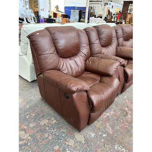 249 - A brown leather three piece lounge suite comprising reclining three seater sofa, electric reclining ... 