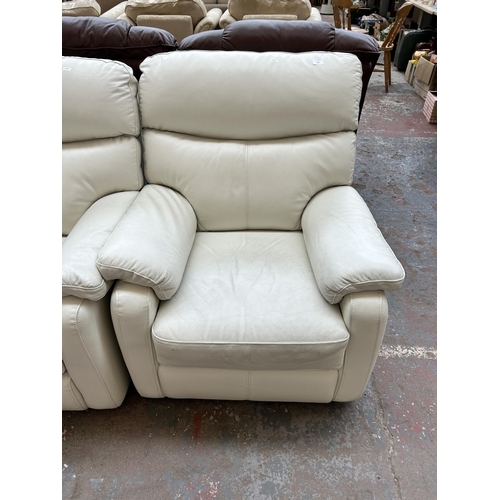 250 - A modern white leather three piece lounge suite comprising two armchairs and two seater sofa