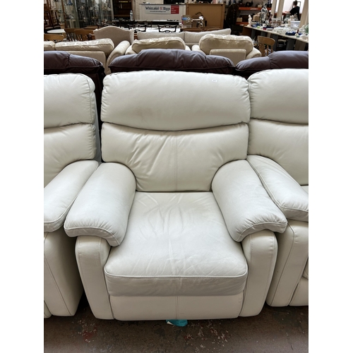 250 - A modern white leather three piece lounge suite comprising two armchairs and two seater sofa