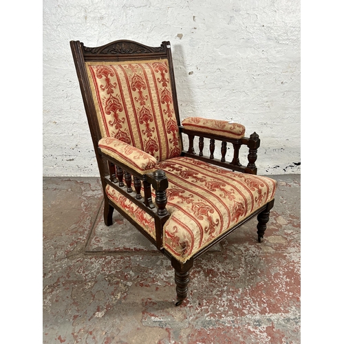 28 - An Edwardian carved oak and fabric upholstered armchair
