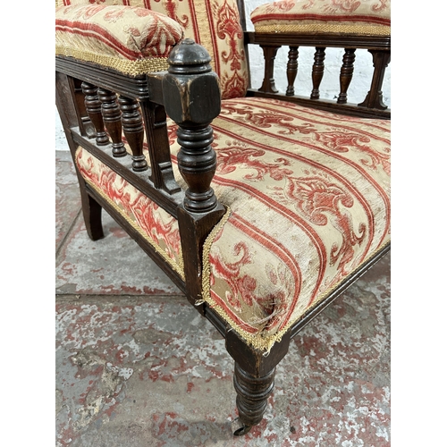 28 - An Edwardian carved oak and fabric upholstered armchair