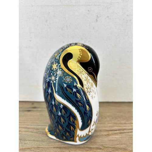 304 - A Royal Crown Derby penguin and chick paperweight with gold stopper - approx. 12.5cm high