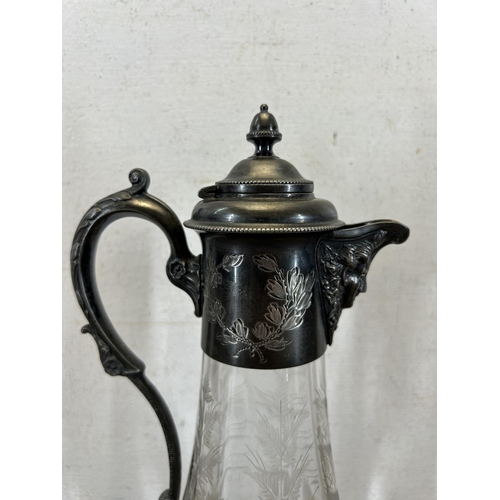 348 - A 19th century style etched glass and pewter claret jug with acanthus leaf design handle and face to... 