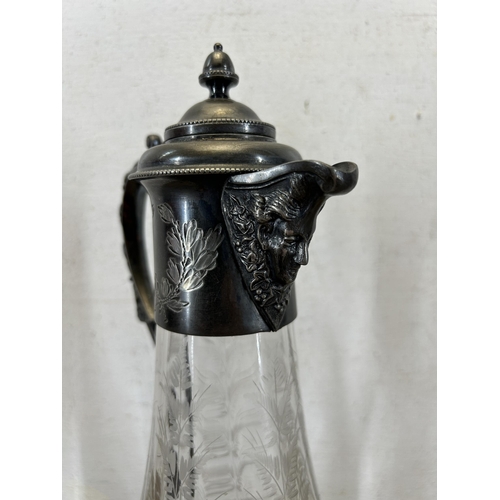 348 - A 19th century style etched glass and pewter claret jug with acanthus leaf design handle and face to... 