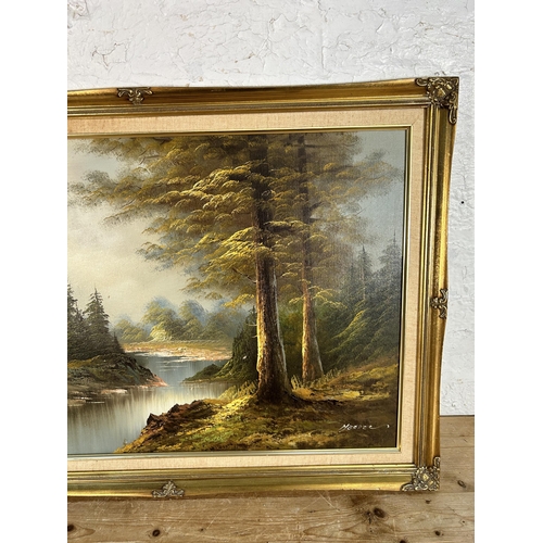 269 - A gilt framed oil on board of a woodland scene, signed lower right - approx. 61cm high x 87cm wide