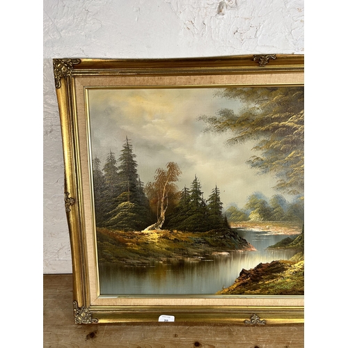 269 - A gilt framed oil on board of a woodland scene, signed lower right - approx. 61cm high x 87cm wide