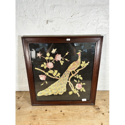 272 - An early 20th century oak framed peacock embroidery - approx. 61cm high x 58cm wide