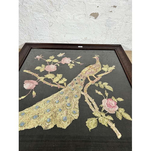 272 - An early 20th century oak framed peacock embroidery - approx. 61cm high x 58cm wide