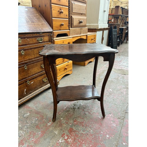 162 - An Edwardian mahogany serpentine two tier side table