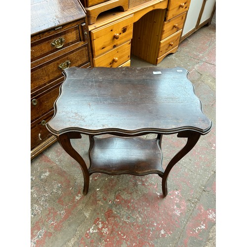 162 - An Edwardian mahogany serpentine two tier side table
