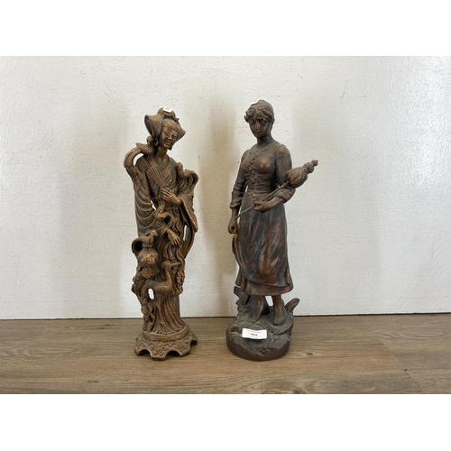 603 - Two 19th century style figurines, one Oriental resin and one cast metal - largest approx. 39cm high