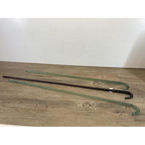 605 - Three 19th century twisted glass dandy sticks - largest approx. 101cm long