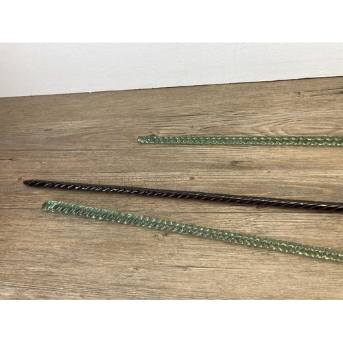 605 - Three 19th century twisted glass dandy sticks - largest approx. 101cm long