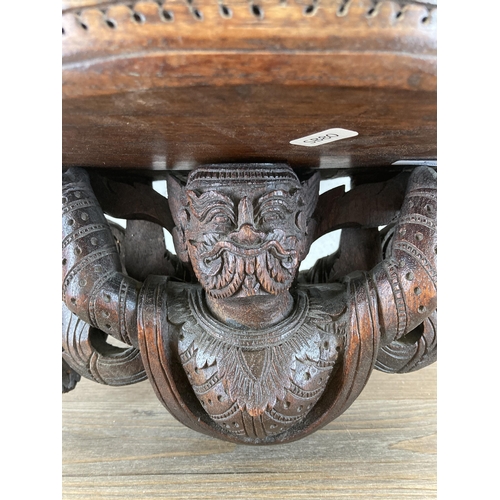 610 - A Burmese heavily carved hardwood wall bracket - approx. 56cm high x 43cm wide