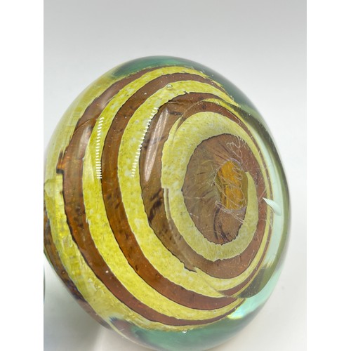 309 - Five art glass paperweights to include three Mdina, Langham Glass etc.