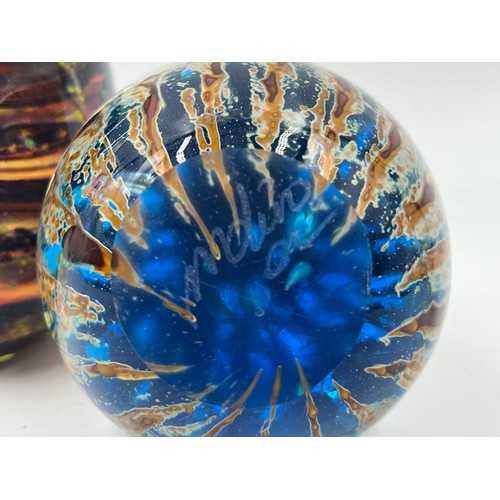 309 - Five art glass paperweights to include three Mdina, Langham Glass etc.